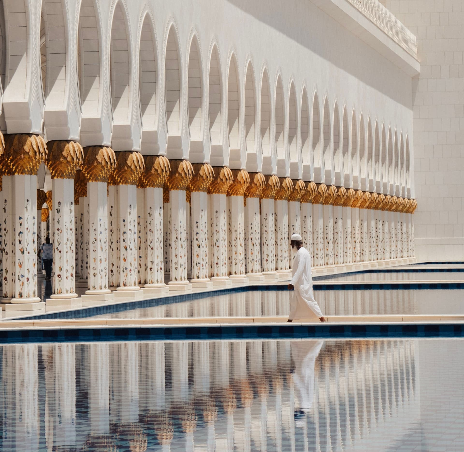 Man walking beside a mosque