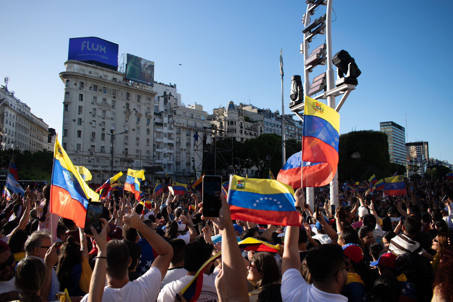 Crowd carrying Venezuelan flags