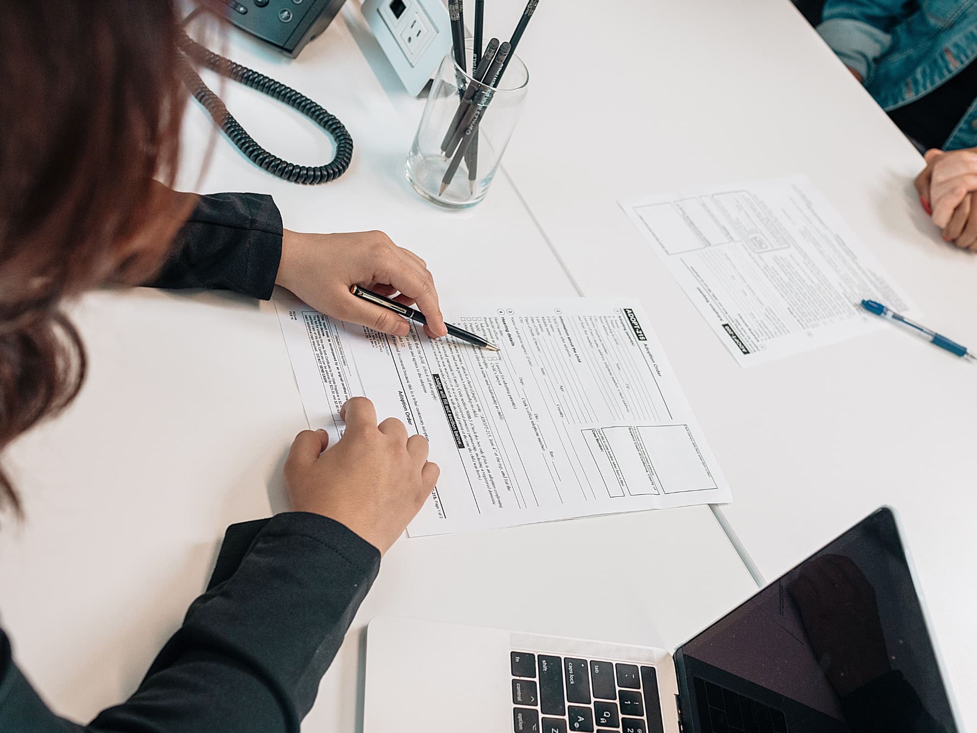 Advisor reviewing tax and legal paperwork at a desk